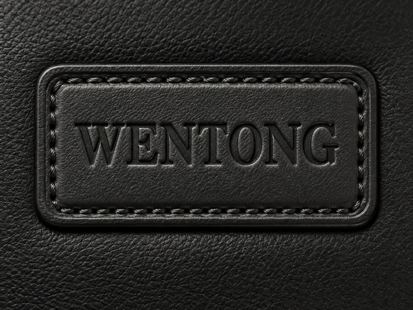 Blind embossed logo on a black leather patch